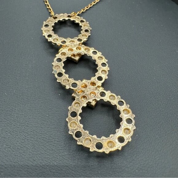 Belladonna Circular Crystal and Gold Tone Infinity Pendant Necklace - Picture 4 of 17